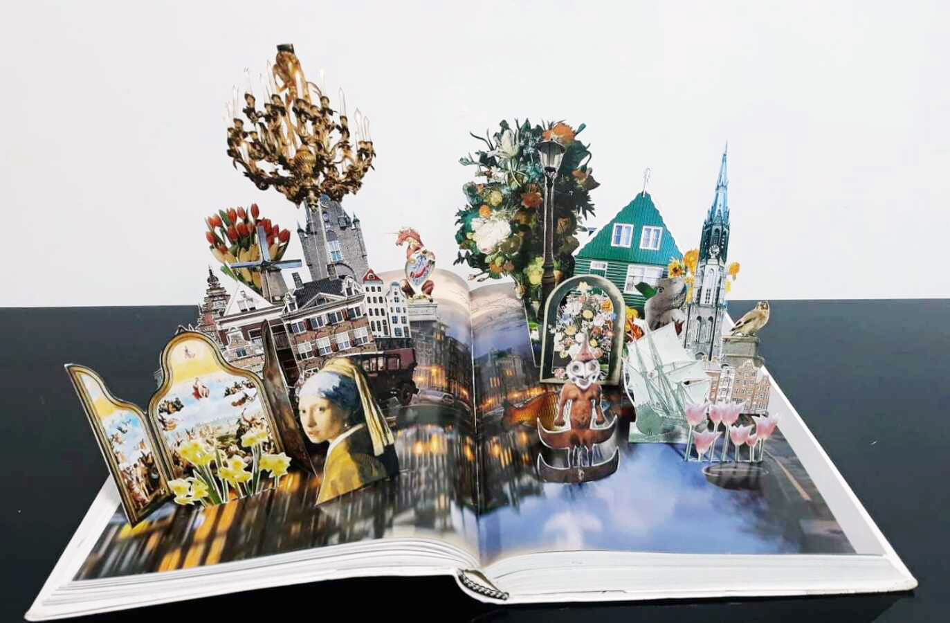 8253 - Daniel Escobar, ''Uma noite em Amsterdam'' série The World, recortes sobre livro e acrílico. 25 x 87 x 23cm, ass. dt. 2022